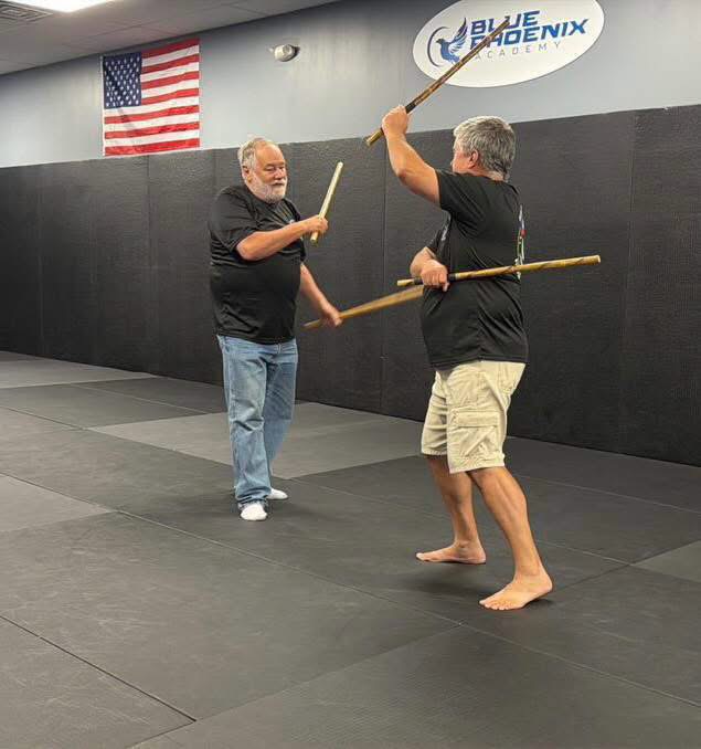 Students practicing Filipino martial arts stick training at Blue Phoenix Academy